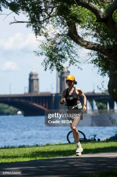 Runner in The Esplanade park along the banks of the Charles River in Boston. Massachusetts. New England. USA.