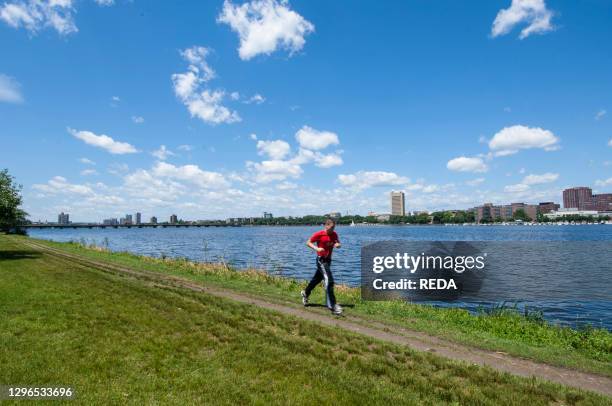 Runner in The Esplanade park along the banks of the Charles River in Boston. Massachusetts. New England. USA.