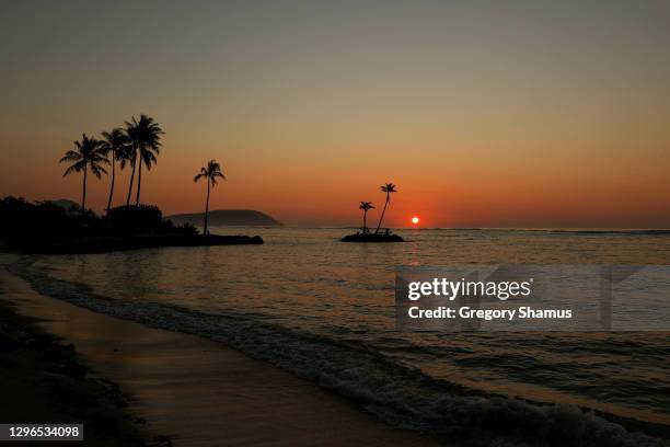 The sun rises over the ocean as seen from the media center during the second round of the Sony Open in Hawaii at the Waialae Country Club on January...