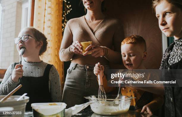 children baking with mum - food stain stock-fotos und bilder