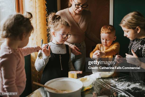 children baking with mum - food stains stock-fotos und bilder