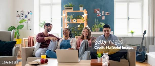 young adults flatmates watching movie indoors, flat sharing concept. - roommate stock-fotos und bilder
