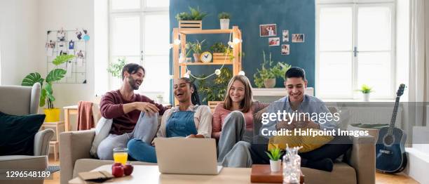 young adults flatmates watching movie indoors, flat sharing concept. - parceiro de apartamento - fotografias e filmes do acervo