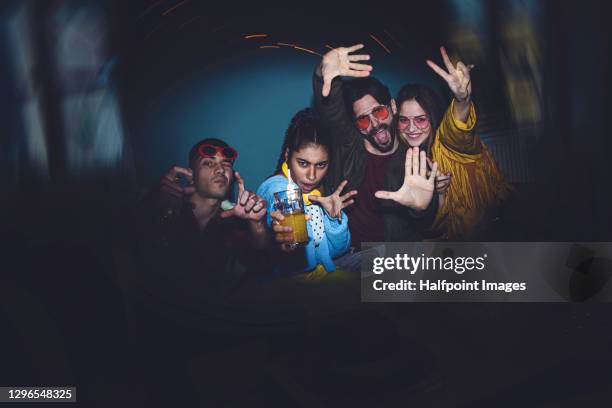 young adults flatmates having party indoors at night, flat sharing concept. - student flat stock-fotos und bilder