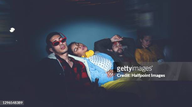 young adults flatmates tired after party indoors at night, flat sharing concept. - student flat stock-fotos und bilder