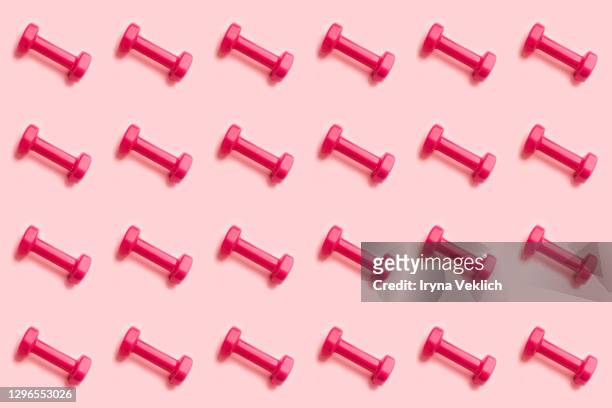 sport lifestyle concept with pattern with pink dumbbells. - mass unit of measurement stock pictures, royalty-free photos & images