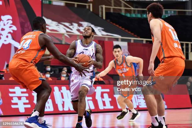 Marcus Georges-Hunt of Sichuan Blue Whales goes to the basket against Andrew Nicholson of Fujian Sturgeons during 2020/2021 Chinese Basketball...