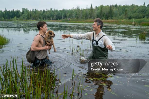 English actor Tom Holland and American film director Doug Liman, both nearly waist-deep in water, on the set of their film 'Chaos Walking' , Quebec,...