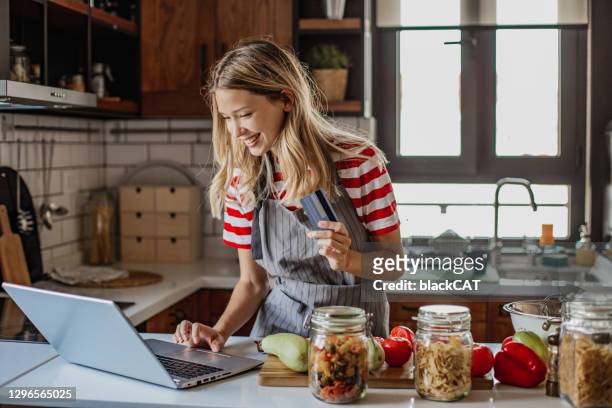 young woman ordering food ingredients online - effortless imagens e fotografias de stock