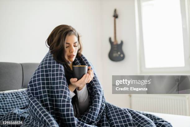 sick woman lying in bed with high fever. cold flu and migraine - woman drinking cold drink stock pictures, royalty-free photos & images