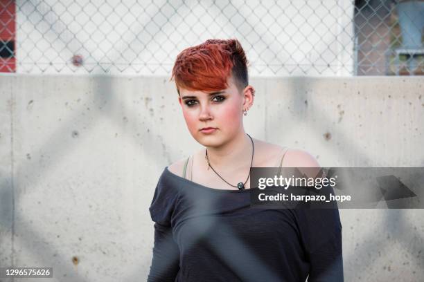 teenage girl behind a chain-link fence. - fashion design minimalist edgy stock pictures, royalty-free photos & images