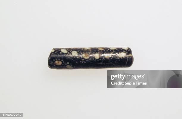 Bead, Roman, Glass, Other: 1 3/8 x 3/8 in. , Glass, Cylindrical black and white opaque bead with large white spots surrounded by smaller dots..