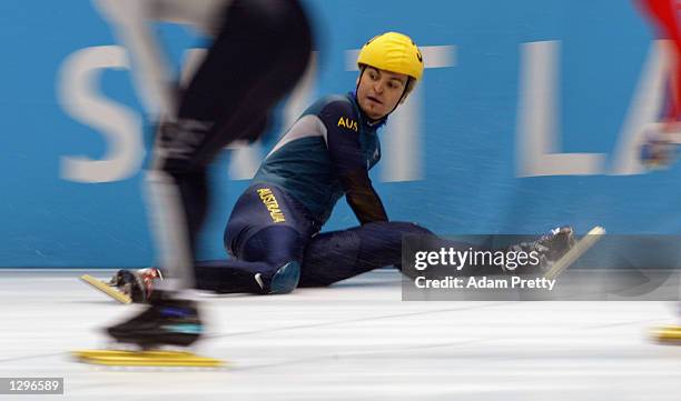 Steven Bradbury of Australia slides across the finish line third to qualify for the semifinal round in the men's 1500m speed skating final during the...