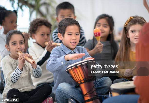 playing the drums in class - percussion instrument stock pictures, royalty-free photos & images