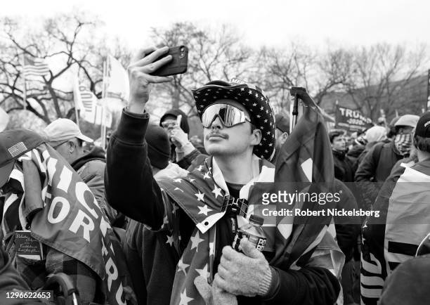 Trump supporter takes a selfie with his iPhone as crowds gather for the "Stop the Steal" rally on January 06, 2021 in Washington, DC. Trump...
