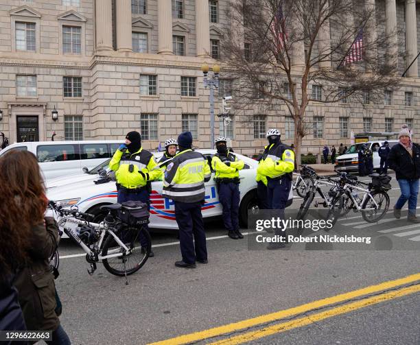 Washington Police Department officers watch as crowds gather for the "Stop the Steal" rally on January 06, 2021 in Washington, DC. Trump supporters...