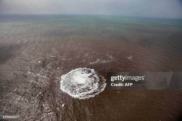 Aerial view taken on October 17, 2011of a green and brown stain at sea off the coast of the village of La Restinga on the Spanish Canary Island of El...