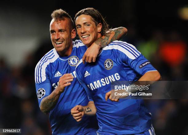 Fernando Torres of Chelsea celebrates with Raul Meireles as he scores their second goal during the UEFA Champions League group E match between...