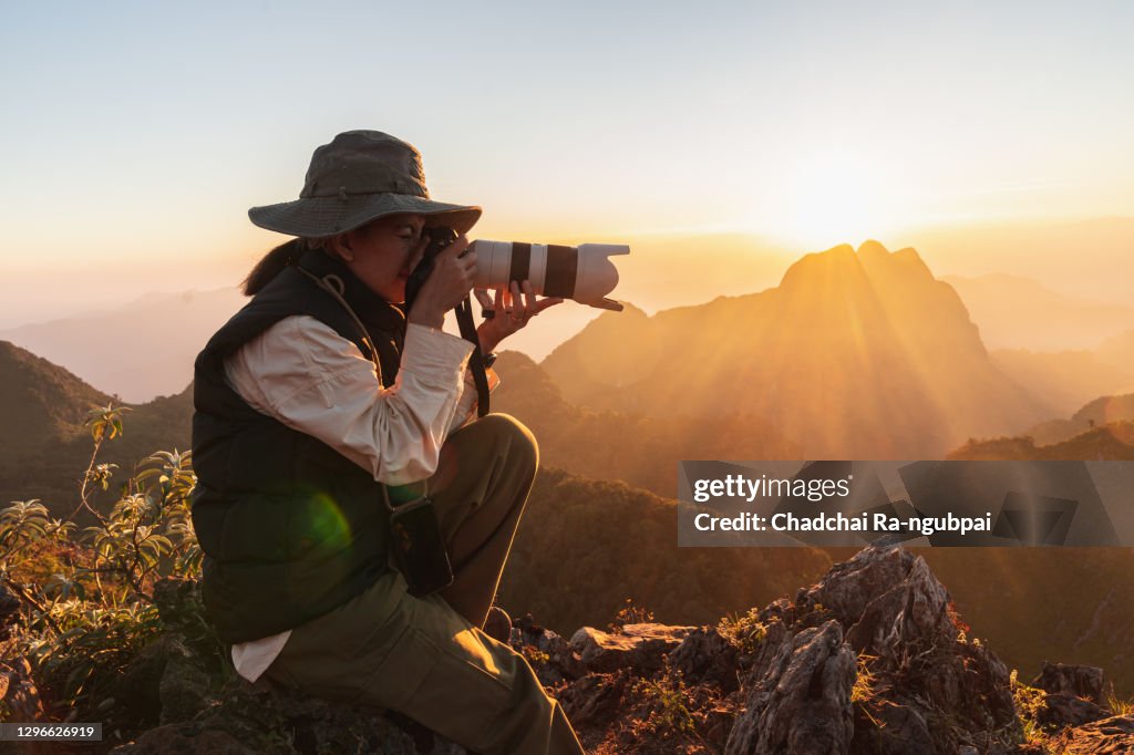 Tourist enjoys sunset with camera at Doi Luang Chiang Dao in Chiang Mai, Thailand.