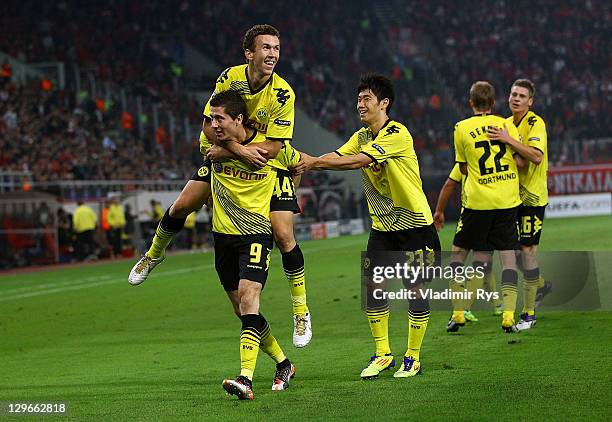 Robert Lewandowski of Dortmund celebrates with his team mates after scoring his team's first goal during the UEFA Champions League group F match...