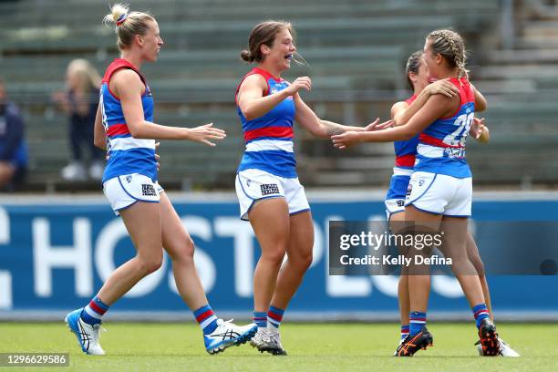 Amelia Oosterwijck of the Bulldogs celebrates her goal with Ellie Blackburn of the Bulldogs and Lauren Spark of the Bulldogs during the AFLW...