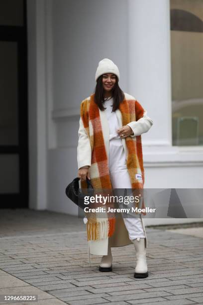 Milena Karl wearing La Marel Jogger, Anine Bing coat, Acne Sudios scarf and hat, Ducie boots and Bottega Veneta bag on January 14, 2021 in Hamburg,...