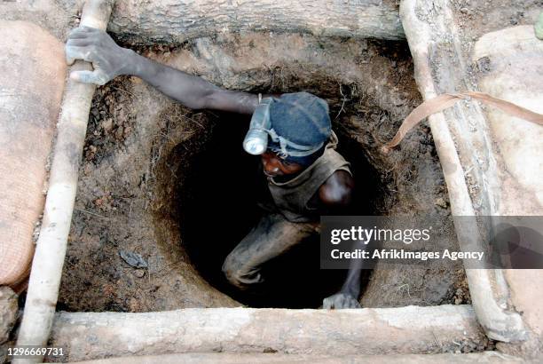 Malian gold panner coming out of an underground mine at an artisanal gold mining site in Sadiola . Gold attracts many young people from the region to...