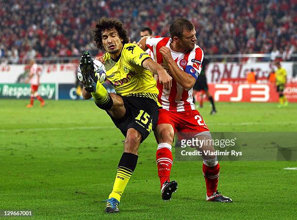 Mats Hummels of Dortmund and Avraam Papadopoulos of Olympiacos battle for the ball during the UEFA Champions League group F match between Olympiacos...