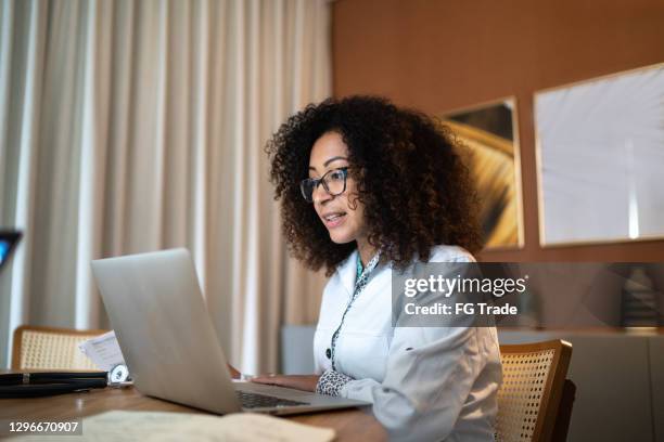 doctor using laptop to talk to patients online - virtual seminar stock pictures, royalty-free photos & images