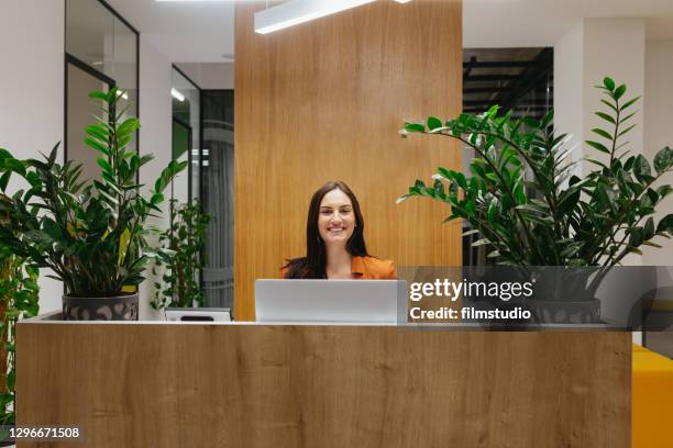 portrait of female lobby receptionist - secretariat stock pictures, royalty-free photos & images