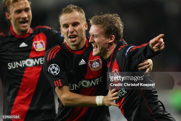 Andre Schuerrle celebrates the first goal with Michal Kaldec and Simon Rolfes of Leverkusen during the UEFA Champions League group E match between...
