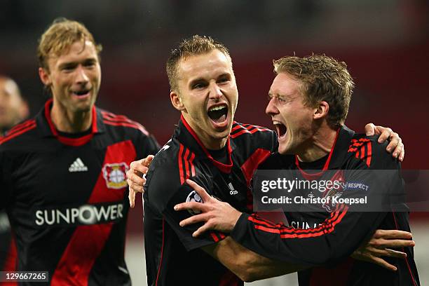 Andre Schuerrle celebrates the first goal with Michal Kaldec and Simon Rolfes of Leverkusen during the UEFA Champions League group E match between...