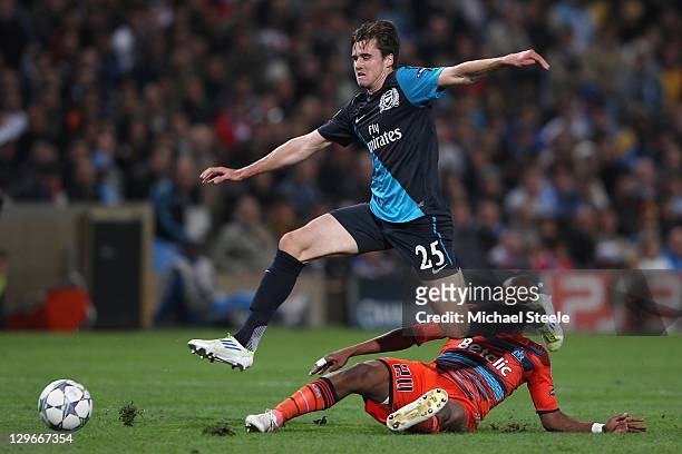 Carl Jenkinson of Arsenal hurdles a challenge from Andre Ayew during the UEFA Champions League Group F match between Olympique de Marseille and...