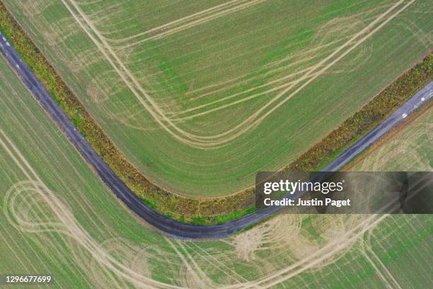 elevated view down onto gravel track through agricultural fields - elevated view of corner stock pictures, royalty-free photos & images