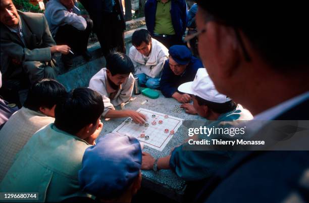 Men are playing Mahjong in Dali on April 1997 in Dali, China. Dali is a city in Yunnan province in the south of China, located on a fertile plateau...