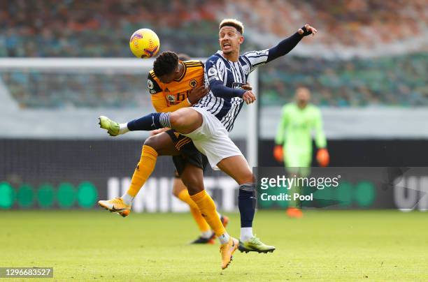 Nelson Semedo of Wolverhampton Wanderers battles for possession with Callum Robinson of West Bromwich Albion during the Premier League match between...