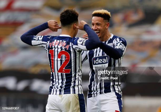 Matheus Pereira of West Bromwich Albion celebrates with teammate Callum Robinson after scoring his team's third goal during the Premier League match...