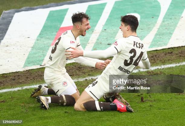 Igor Matanovic of FC St. Pauli celebrates with teammate Leart Paqarada after scoring his team's third goal during the Second Bundesliga match between...