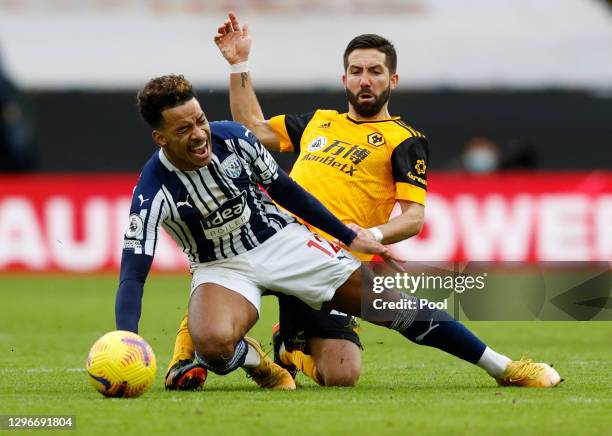 Matheus Pereira of West Bromwich Albion is challenged by Joao Moutinho of Wolverhampton Wanderers during the Premier League match between...