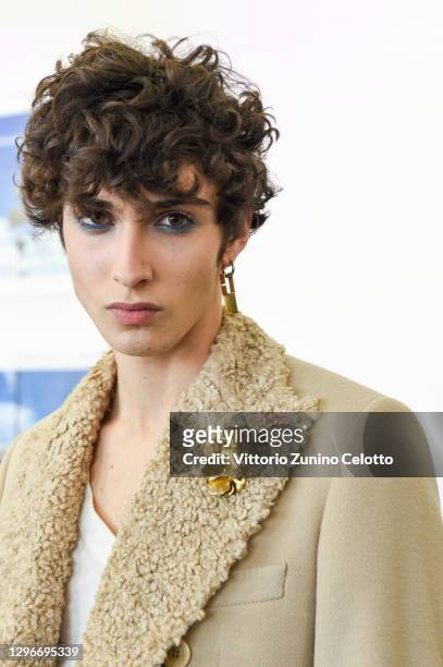 In this image released on January the 16th, a model is seen in the backstage at the Miguel Vieira Fashion Show during the Milan Men's Fashion Week...