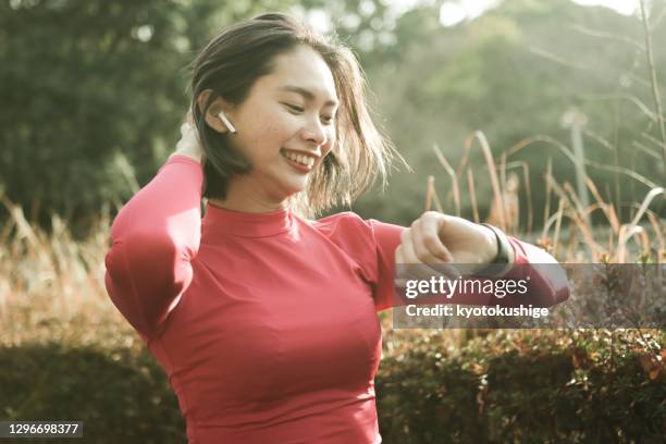 young asian woman running outside - asian woman smiling sunrise ストックフォトと画像
