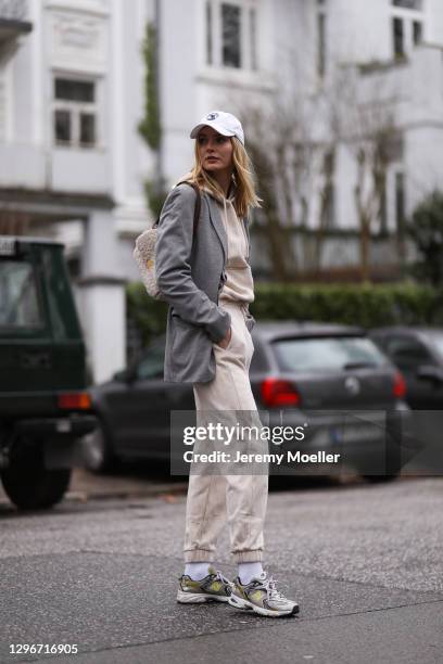 Eva Staudinger wearing SoSue jogging suit, white cap, New Balance sneaker and Boss blazer on January 14, 2021 in Hamburg, Germany.