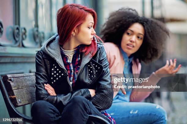 girlfriends in conflict are sulking each other - pleading stock pictures, royalty-free photos & images