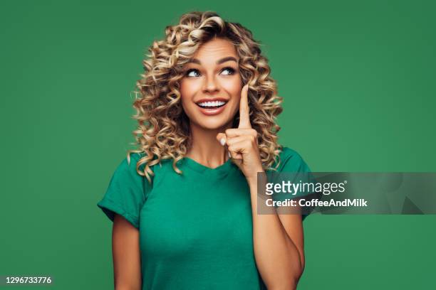 beautiful young woman pointing at copy space - index finger stock pictures, royalty-free photos & images