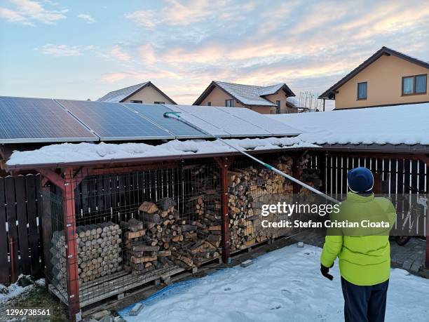 man cleaning solar panels - solar panel city stock-fotos und bilder