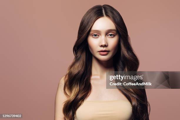 studio portrait of a young beautiful girl - wavy brown hair stock pictures, royalty-free photos & images