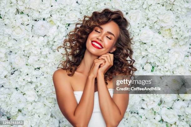beautiful woman with curly hair - beautiful woman roses stock pictures, royalty-free photos & images