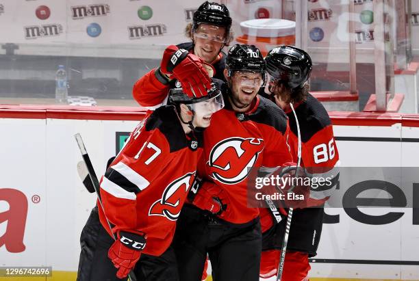 Egor Sharangovich of the New Jersey Devils is congratulated by teammates Dmitry Kulikov, Jack Hughes and Jesper Boqvist after he scored the game...