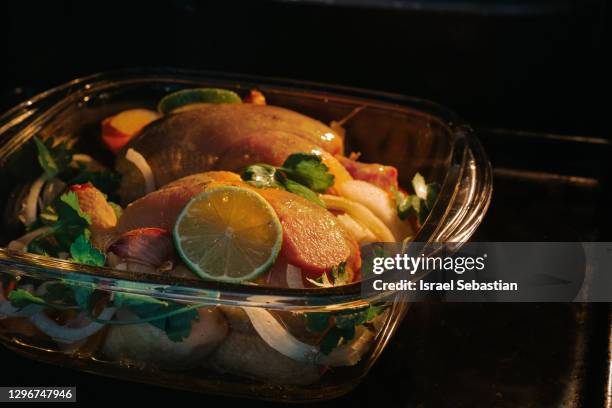 close-up chicken with vegetables inside hot oven while cooking in kitchen at home - chicken roasting oven stock pictures, royalty-free photos & images