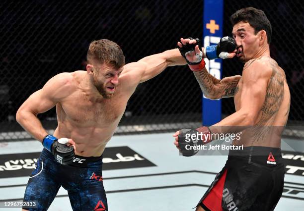 Calvin Kattar punches Max Holloway in a featherweight bout during the UFC Fight Night event at Etihad Arena on UFC Fight Island on January 17, 2021...